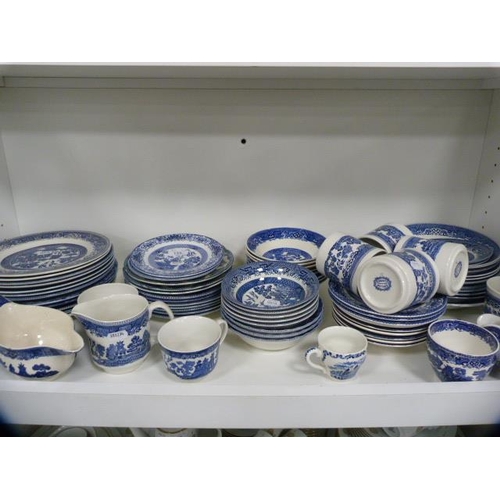 135 - Collection of blue and white 'Willow' and 'Old Willow' pattern tablewares (one shelf).