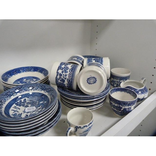 135 - Collection of blue and white 'Willow' and 'Old Willow' pattern tablewares (one shelf).