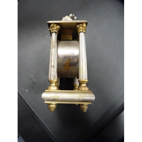 175 - Antique metal Corinthian-style mantel clock with silvered dial.