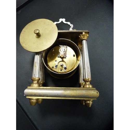 175 - Antique metal Corinthian-style mantel clock with silvered dial.