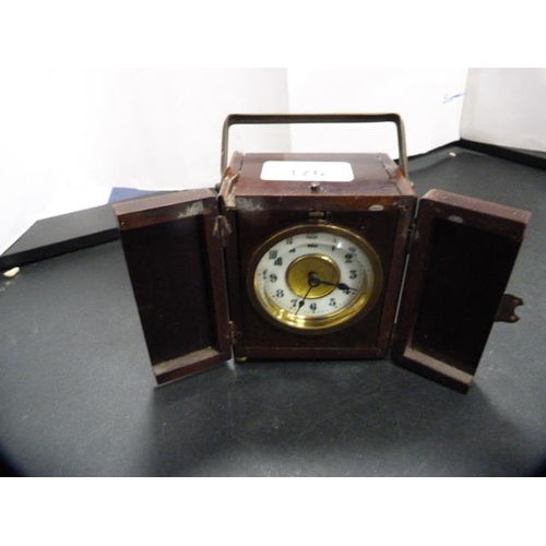 176 - Desk or travel clock in a stained wood case, c. early 20th century.