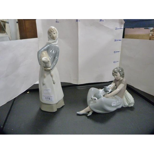 178 - Lladro figure of a girl holding a lamb and a Nao figure of a girl playing with a kitten.  (2)