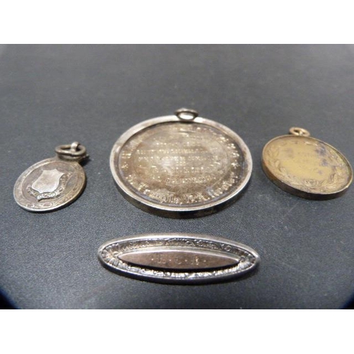 218 - Late Victorian silver school medal, dated 1901-2, another small silver medal fob, a silver medal dat... 