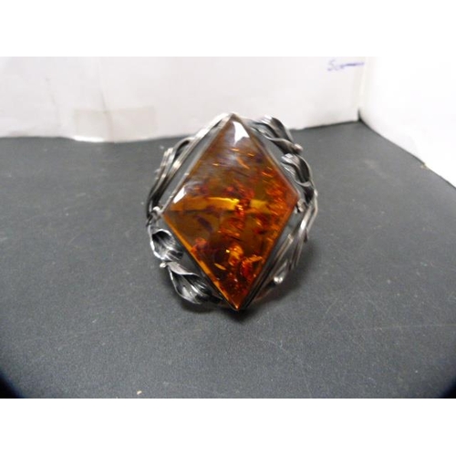 236 - Modern silver and faux amber-set bangle, 59g gross.