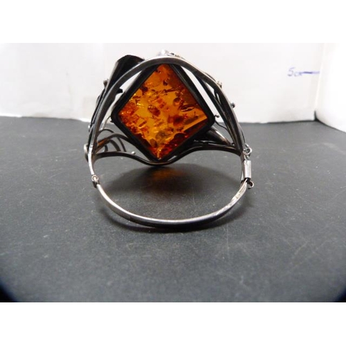 236 - Modern silver and faux amber-set bangle, 59g gross.