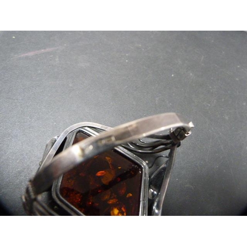 236 - Modern silver and faux amber-set bangle, 59g gross.