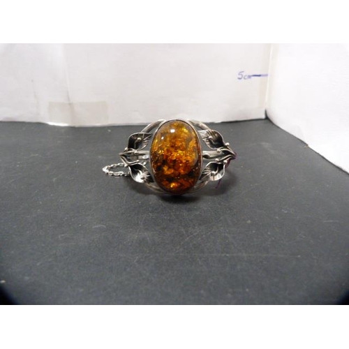 237 - Modern silver and faux amber-set bangle, 45.9g gross.