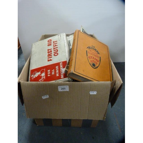 265 - Carton containing a stamp album, art magazines, jigsaws, cutlery case etc.