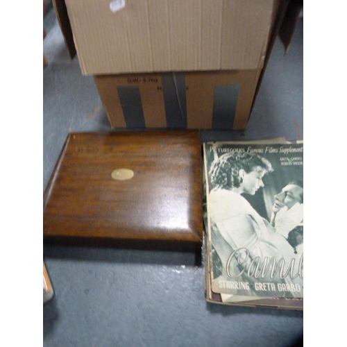 265 - Carton containing a stamp album, art magazines, jigsaws, cutlery case etc.