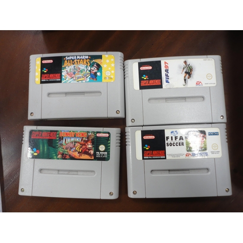 272 - Super Nintendo console, controller and four games.