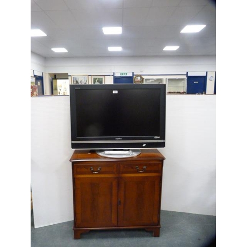 324 - Modern yew wood side cabinet and a Sony Bravia television.  (2)