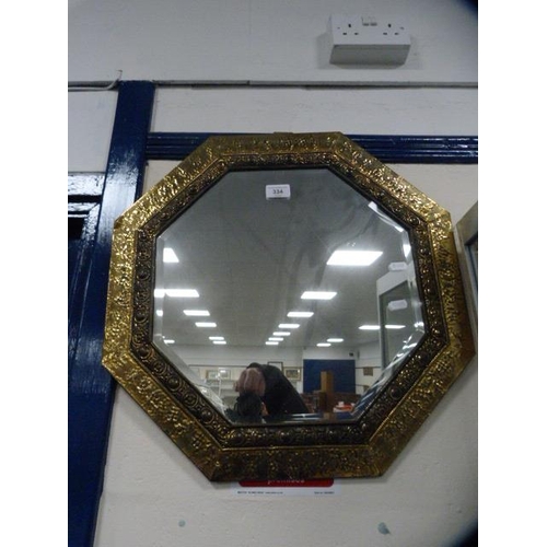 334 - Brass hammered octagonal wall mirror.