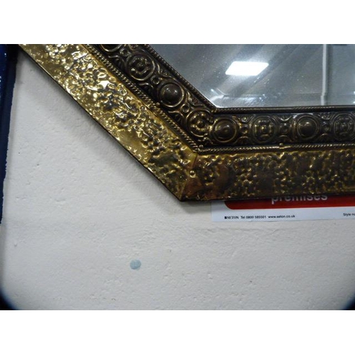 334 - Brass hammered octagonal wall mirror.