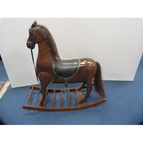 335 - Indian-style hardwood rocking horse on cradle support.