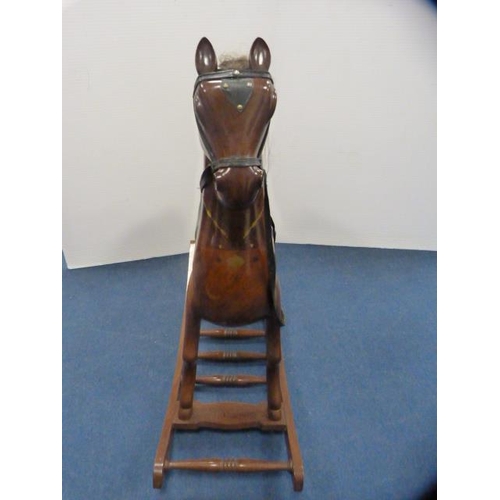 335 - Indian-style hardwood rocking horse on cradle support.