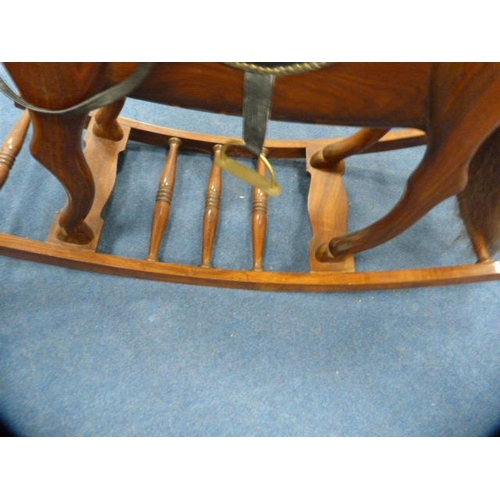 335 - Indian-style hardwood rocking horse on cradle support.