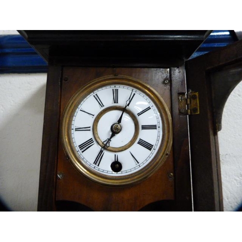 53 - Walnut and ebonised wall clock of small proportions.