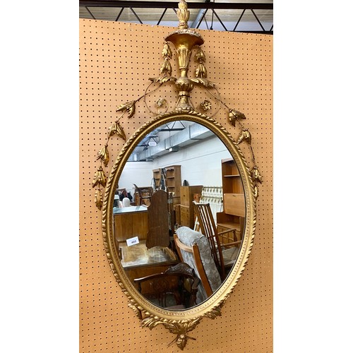 460 - Ornate gilt framed mirror with floral decoration, 68cm x 49cm (128cm x 64cm)