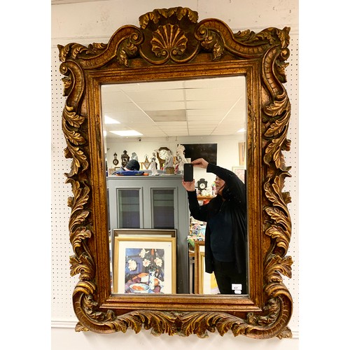 437 - Large ornate mirror in gilded wood frame, 88.5cm x 58cm (mirror)