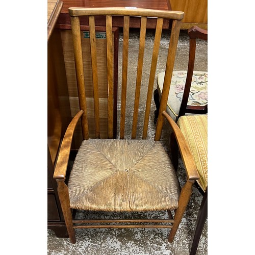 664 - Arts and crafts oak open arm chair with rush seat.