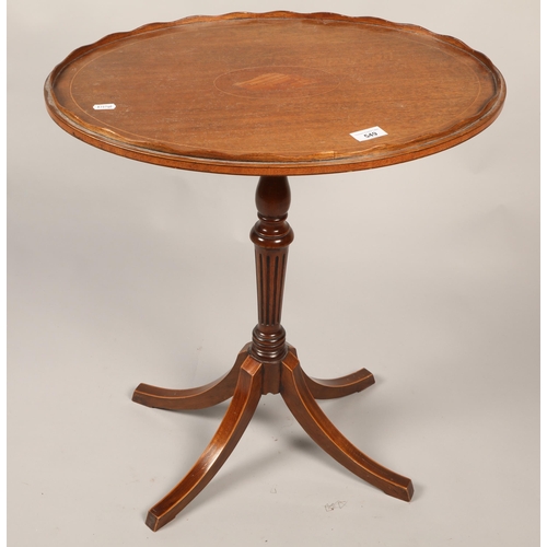 549 - Mahogany pedestal table with marquetry inlay shell on top with scalloped edge.