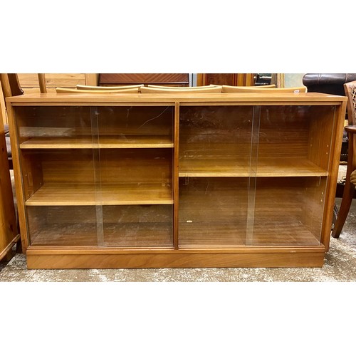 585 - Teak glazed bookcase ,H 77cm, W 136cm, D 28cm