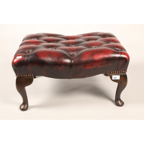 592 - Wine leather button top footstool.