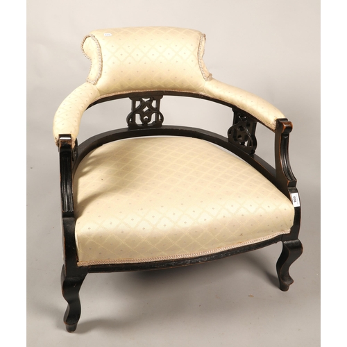 608 - Tub chair with cream upholstery and carved hardwood surround