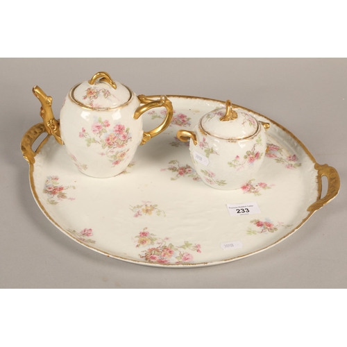 233 - Limoges floral and gilt decorated teapot and sugar bowl on a twin handled circular tray.