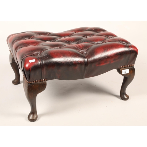 592 - Wine leather button top footstool.