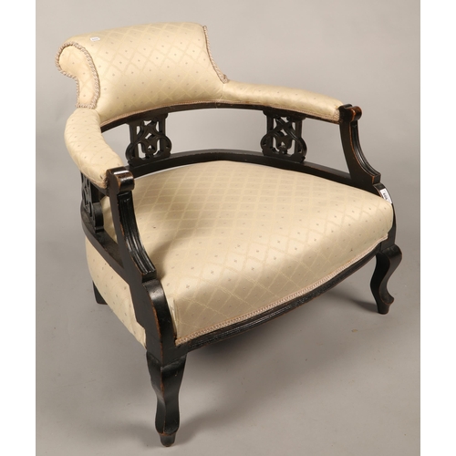 608 - Tub chair with cream upholstery and carved hardwood surround