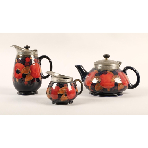 12 - Moorcroft pottery Tudric pewter three piece tea service, pomegranate pattern designed by William Moo... 