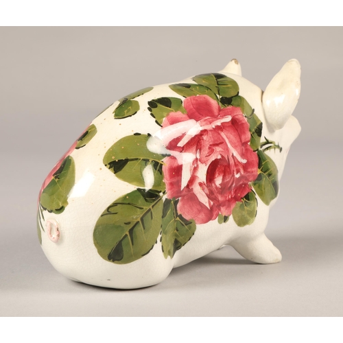 22 - Wemyss ware pig, hand painted with cabbage rose decoration, 16cm long.