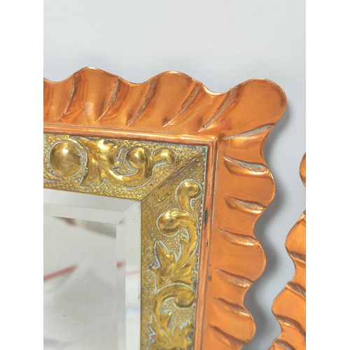 395 - Pair of Aesthetic Movement copper and brass girandole wall mirrors, each with a wavy copper border, ... 