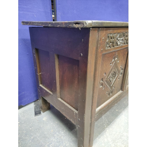 449 - Antique oak coffer with triple panelled front, with carved quatrefoils and frieze, the cover later (... 