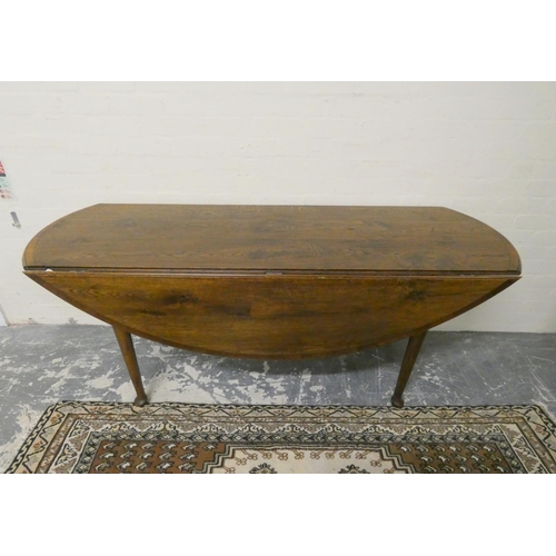 467 - Antique style oak wake table with curved ends and extending drop leaf sides, raised on pad feet, 77c... 