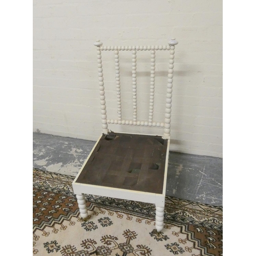 501 - Antique painted bobbin turned chair on brass caps and castors, 101cm high.