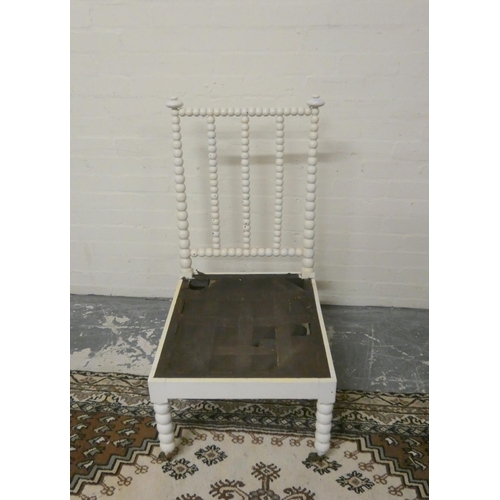 501 - Antique painted bobbin turned chair on brass caps and castors, 101cm high.