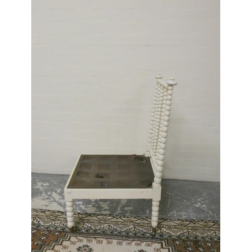 501 - Antique painted bobbin turned chair on brass caps and castors, 101cm high.