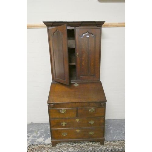 502 - 18th century oak bureau bookcase, the bookcase top with two panel doors enclosing shelved interior a... 