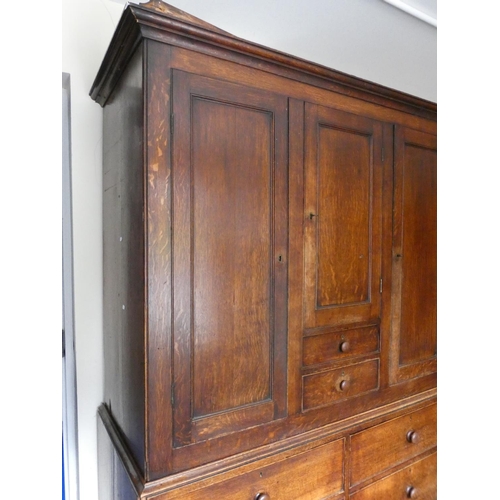 506 - Georgian oak linen press cupboard circa early 19th century of large proportions, the top section wit... 