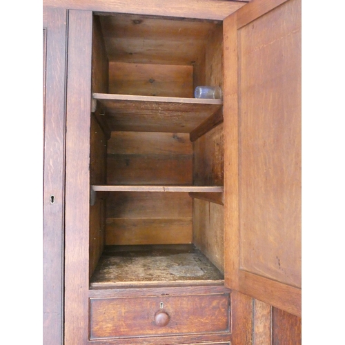 506 - Georgian oak linen press cupboard circa early 19th century of large proportions, the top section wit... 