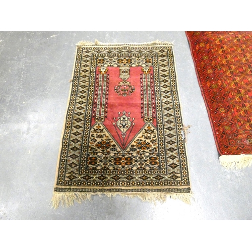 443 - Bokhara rug on red ground, 126cm x 80cm with Afghan rug, 115cm x 80cm (2)