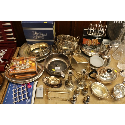 108 - Silver-plated wares to include an oval tray, three-piece tea service, a pair of candlesticks, a card... 