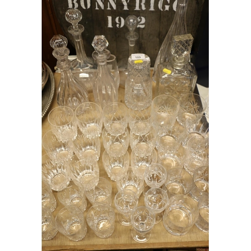 109 - Mixed suite of glassware to include seven decanters, a thistle etched vase, tumblers, and other, dri... 