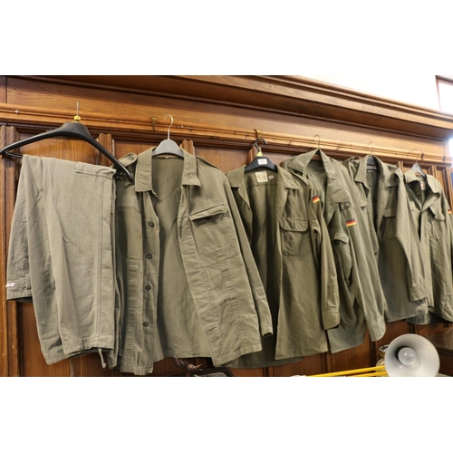 113 - Five grey green German army style jackets, and a pair of trousers.