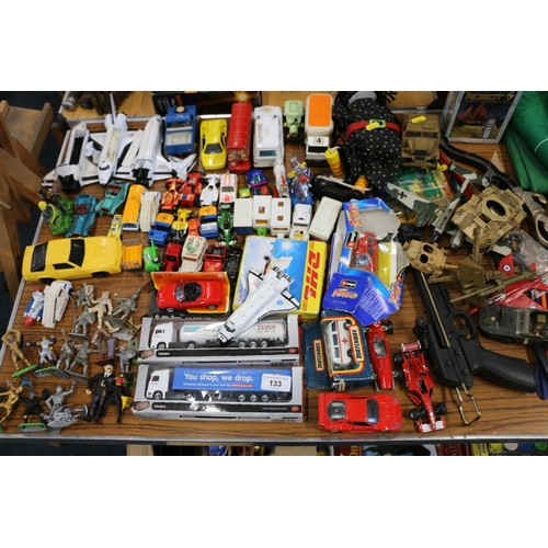 133 - Toys to include a bow and arrow, a slingshot, boxed tractor and trailer models, Tesco articulated lo... 