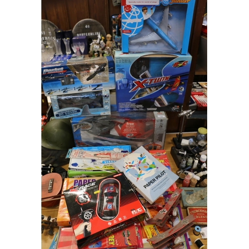 144 - Toys to include a radio control boat, aircraft, a helicopter, paper aeroplanes, etc.