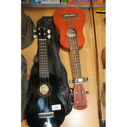 147 - Two ukuleles to include a Clifton Soprano #067286 and a Malani #UKS30BK.