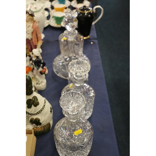 216 - Glass decanters and a glass apple paperweight.